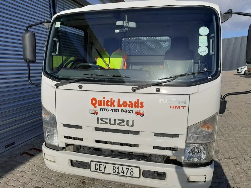 Truck front with Quick Loads logo and contact details